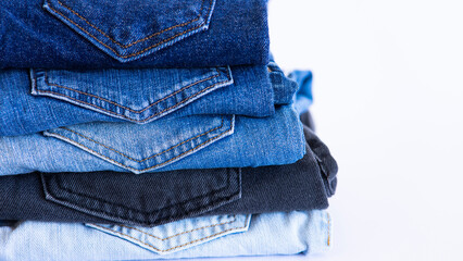 jeans on the background, blue and black jeans lie on a white background,