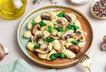 Gnocchi in a creamy sauce with mushrooms and spinach. Healthy eating. Vegetarian food.