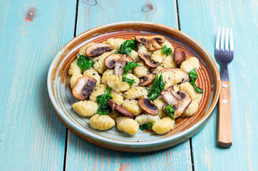 Gnocchi in a creamy sauce with mushrooms and spinach. Healthy eating. Vegetarian food.