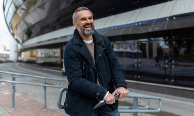 charismatic adult bearded man with laptop outside