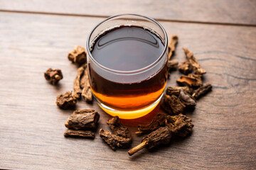 Raw dried Indian Ayurvedic Sarsaparilla or anantmool with Kadha drink or Tea