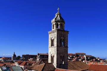 Fototapeta na wymiar slim tower above the Dominican Monastery with classic red tiled rooftops inside the old town of Dubrovnik, Croatia