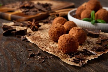 Homemade Chocolate Truffles with Cocoa Powder on Brown Wooden Table.