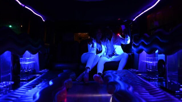 African American couple taking selfie in limousine