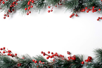New Year's composition. top view on a white background. Fir branches, red berries. Place for your text