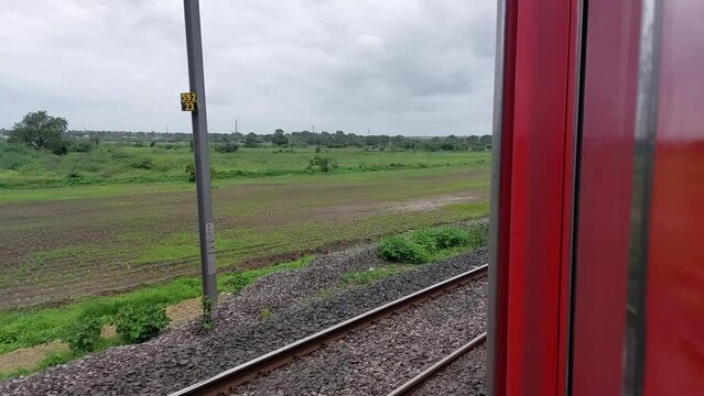 horizontal long video of green farms, fields, landscapes and grassland from moving train door