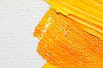 Beautiful strokes of yellow and orange oil paints on white canvas, closeup - obrazy, fototapety, plakaty