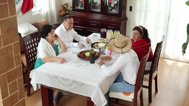 Happy Mexican Family Laughing At Joke During Lunch