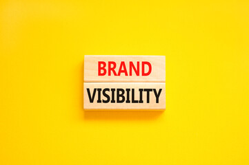 Brand visibility symbol. Concept words Brand visibility on wooden blocks. Beautiful yellow table...