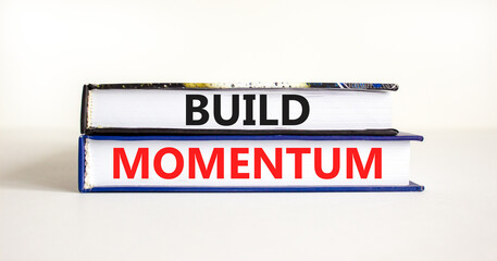 Build momentum symbol. Concept words Build momentum on books. Beautiful white table white background. Business and build momentum concept. Copy space.