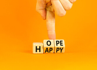 Hope and happy symbol. Concept words Hope and Happy on wooden cubes. Beautiful orange table orange background. Businessman hand. Business hope and happy concept. Copy space.