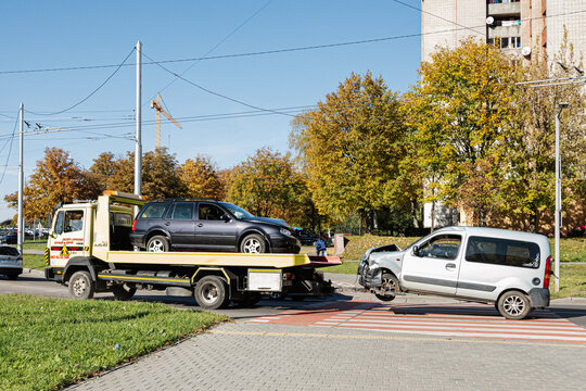 Lviv, Ukraine - October 09, 2022: Broken car on a tow truck. Damage vehicle after crash accident.