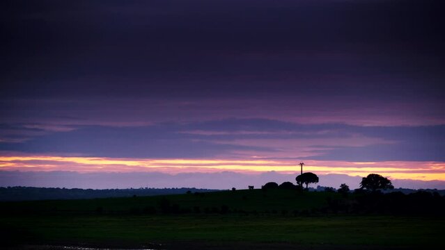 Time lapse of evening dark clouds moving over field, countryside landscape, district of Evora in Portugal Europe.