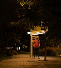 Man waits in the bus station at night