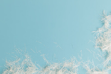 creative festive frame with white streamers on blue pastel background, top view