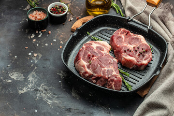 Raw fresh meat steaks on frying pan on a dark background. banner, menu, recipe place for text, top view