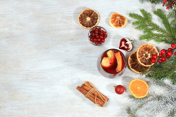Strong alcoholic or non-alcoholic cocktail with cranberry, apple, orange and cinnamon, mulled wine, warming winter drink in the cold season, Christmas festive grog, winter composition, selective focus