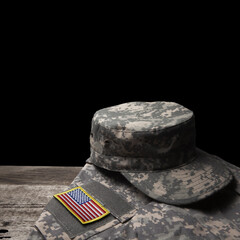 USA military uniform with insignias on old wooden table on black background. Memorial Day or...
