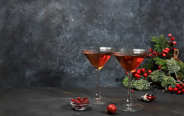 Strong alcoholic cocktail with cranberry and cinnamon, warming winter drink in the cold season,...