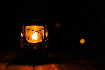 Fototapeta na wymiar Kerosene lamp at the garden table during the night.