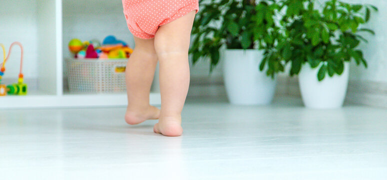 Baby Feet Learning To Walk. Selective Focus.