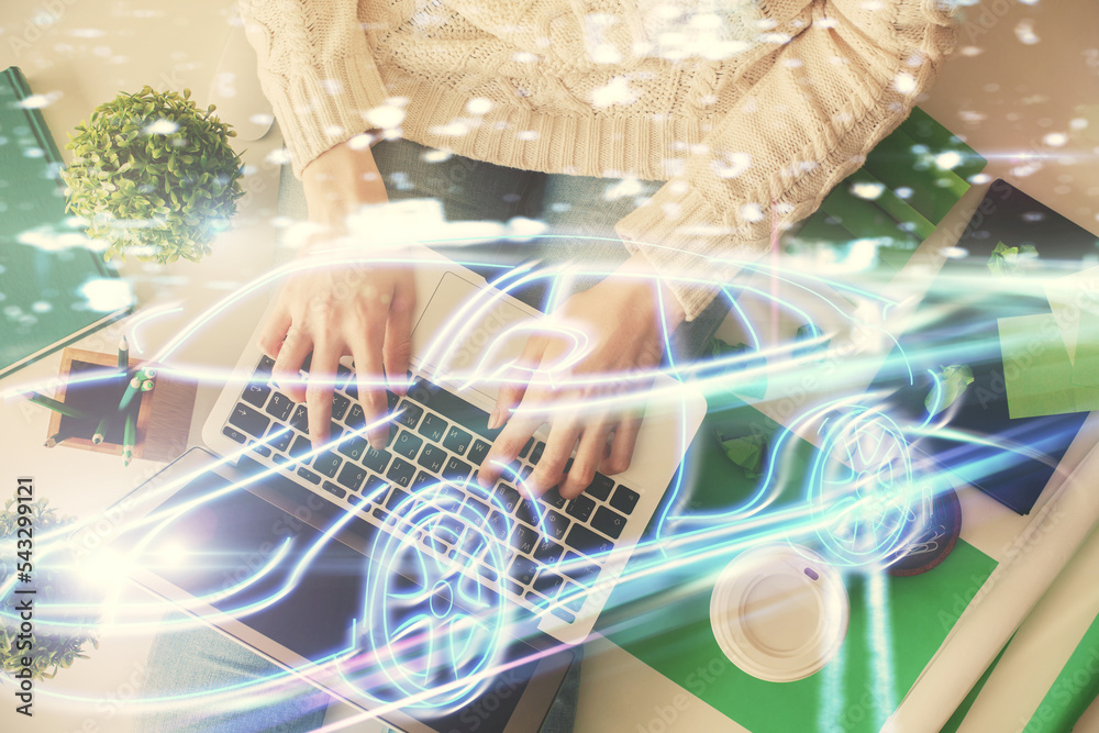 Poster double exposure of woman hands working on computer and car hologram drawing. top view. auto pilot co