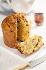 Panettone Christmas Cake. Italian sweet bread on white kitchen table.