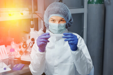 Medical worker or Scientist in a medical research laboratory holds a test tube.