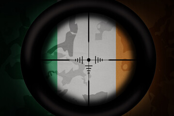 sniper scope aimed at flag of ireland on the khaki texture background. military concept. 3d illustration