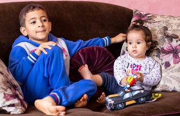 baby and his brother playing at home 