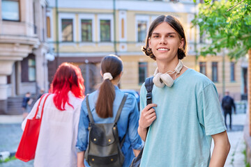 Portrait of teenage guy looking at camera outdoor