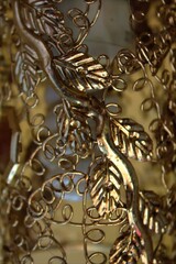 Fototapeta na wymiar Metal decorative chandelier element with bokeh effect