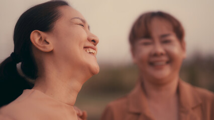 Close-up of a happy Asian woman laughing.