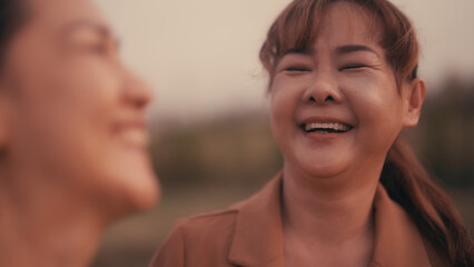 Close-up of a happy Asian woman laughing.