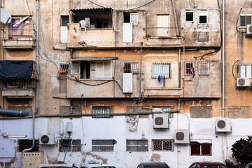 Facade of old building with open windows and balconies in poor district Neve Shaanan, Tel Aviv,...