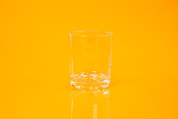 empty glass empty jar empty ice bucket on orange background