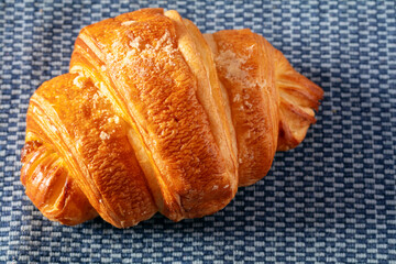 fresh baked croissant on wooden table.