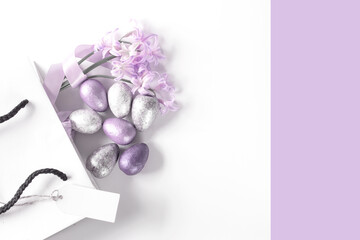 White gift box with spring pink lilac flowers on white background. Flat lay, top view. Concept of trendy digital lavender color. Place for text