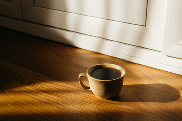 a cup of coffee on the parquet floor