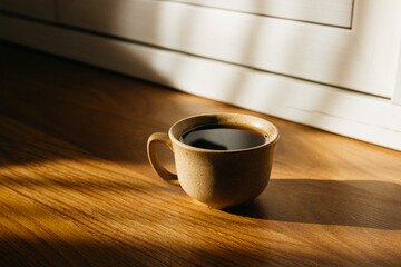 a cup of coffee on the parquet floor