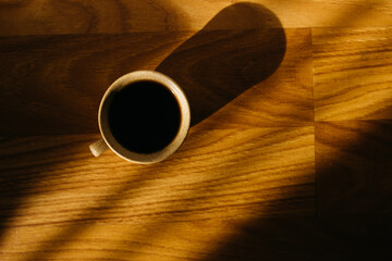 a cup of coffee on the parquet floor