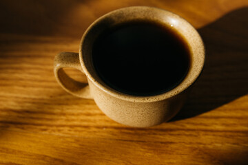 a cup of coffee on the parquet floor