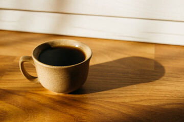 a cup of coffee on the parquet floor