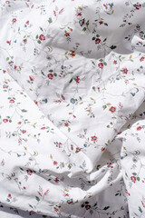 crumpled cotton bed linen in bedroom, closeup
