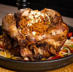 Whole roasted chicken  with vegetables stuffed with rice, on wooden table, delicious chicken