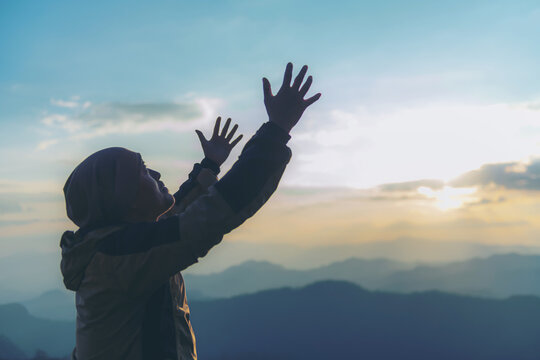 The human hand raises his palm open to worship. Eucharist, bless the Lord, help Catholics repent of Easter. behind the concept of Christianity Battle and Victory for God