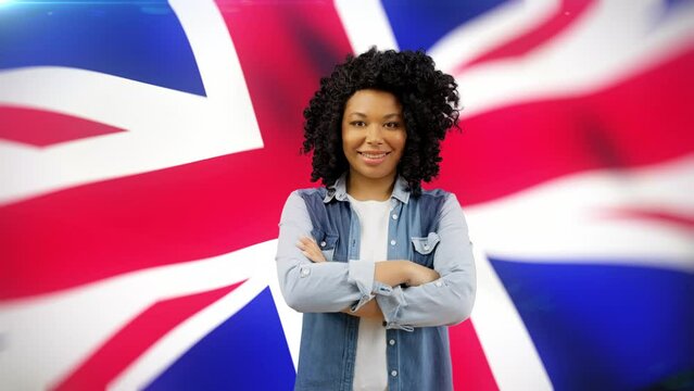 Smiling black woman posing in front of United Kingdom flag, polling place, voter