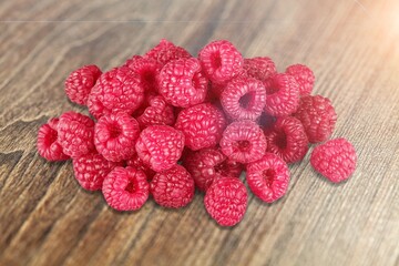 Fresh tasty ripe juicy fresh raspberries on kitchen desk.