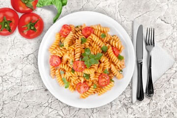 Italian pasta dish with cheese, tomato and fresh vegetables.