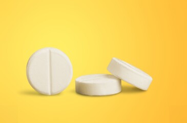 White vitamin pill on color background